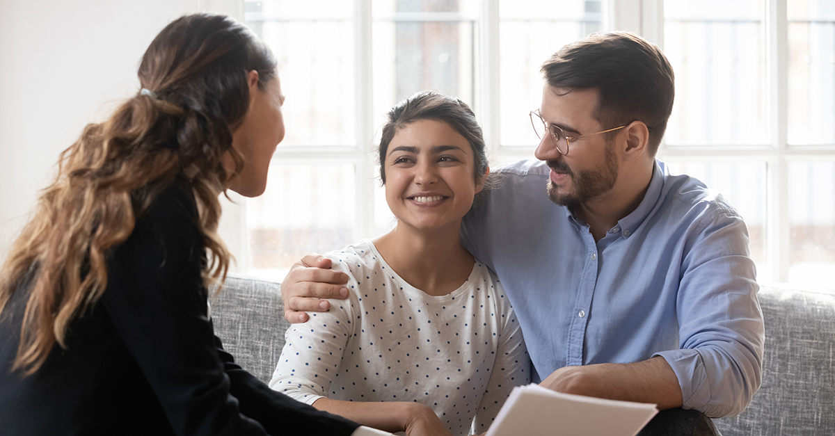 A couple meets with their real estate agent