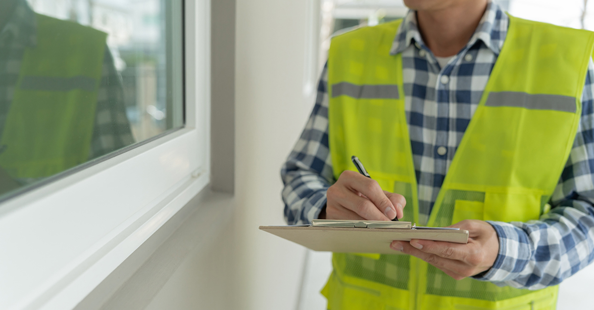 A home inspector checking the windows